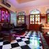 Riad Fatouma in Marrakech lounge with stained-glass windows and black-and-white checkerboard floor