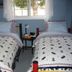 The Grateful Bed B'nB in Prince George, twin beds with patterned quilts beside a window