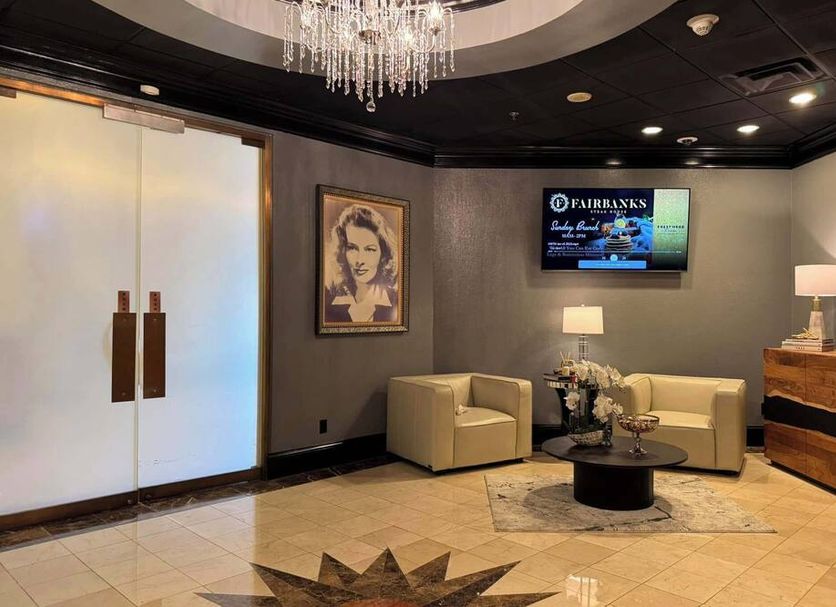 Lobby lounge at Hollywood Casino Tunica in Tunica Resorts with chairs, chandelier and wall TV