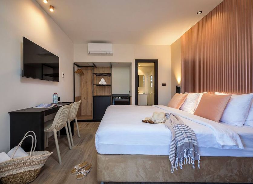 Sahara Hotel Eilat room with king bed, desk, wall TV and open wardrobe in Eilat