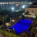 Le Palazzine Hotel in Vlorë with lit outdoor pool and bay view at night