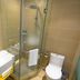 Anyi 158 Hotel Renming Park bathroom in Chengdu with glass shower, sink and toilet