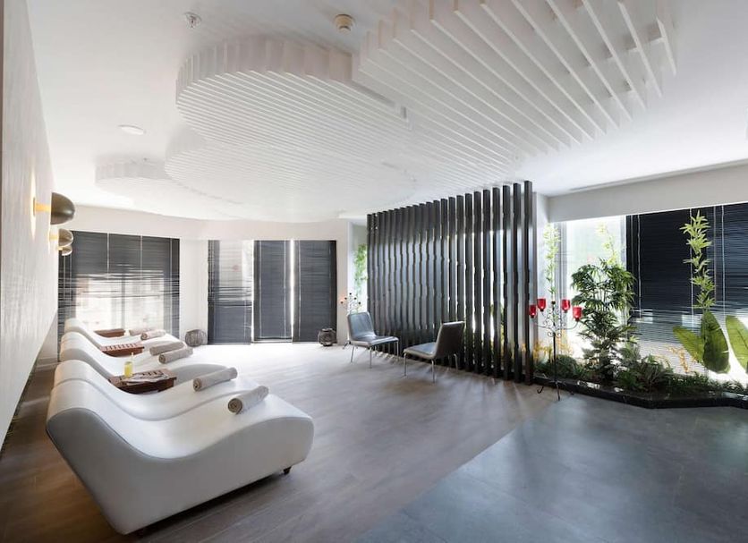 Akra Kemer spa lounge in Kemer with curved seating, indoor plants, and floor-to-ceiling windows