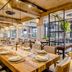 Buenos Aires Ezeiza Airport Marriott dining room with long set tables, pendant lights and open glass partitions in Buenos Aires