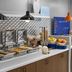 Holiday Inn Express & Suites Montrose breakfast bar with hot buffet trays, cereal dispensers and fruit