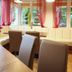 Hotel Bohemia in Františkovy Lázně lounge with cream seating, red curtains and garden views