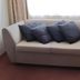 Midtown Motor Inn in Whanganui, sofa with four dark blue pillows beside a window