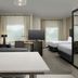 Residence Inn by Marriott Doral Mall Area suite with two beds, TV, desk and a city-view window in Doral