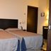 Hotel I' Fiorino in Capraia Fiorentina guest room with two twin beds and bedside lamps