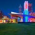 Embassy Suites by Hilton Atlanta at Centennial Olympic Park exterior with colorful skyline-lit facade