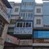 Vrp Guest House in Bhuj exterior with blue facade and Green Rock A/C Restaurant sign