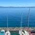 Hôtel Des Princes in Évian-les-Bains overlooking a calm lake with sailboats by a rocky pier