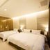 823 Tourist Hotel in Jinhu Township guest room with two double beds and warm modern lighting