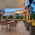 Embassy Suites by Hilton Raleigh Durham Airport Brier Creek patio with shaded seating and string lights in Raleigh