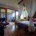 The Kirana Canggu Hotel in North Kuta, four-poster bed in a spacious guest room with sitting area