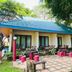 Sri Phairin Resort in Chanthaburi with a blue-roofed bungalow and tiled patio surrounded by trees