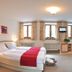 Gästehaus Enzianhof Hotel Garni in Oberammergau room with twin beds, windows, desk and chair