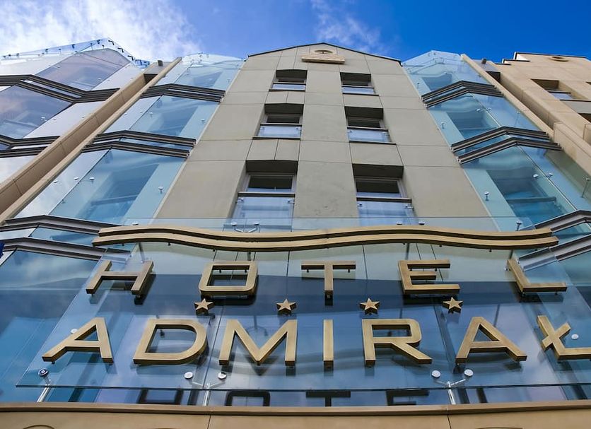 Hotel Admiral in Gdansk exterior with glass facade and large sign
