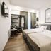 Hotel Citadel Narikala room in Tbilisi with two beds, TV, wardrobe and large wall map