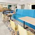 Hampton Inn & Suites Fort Worth/Forest Hill lobby seating area with blue sofa and tables in Forest Hill