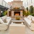 Emeline Charleston courtyard with brick fireplace, lounge seating and potted flowers