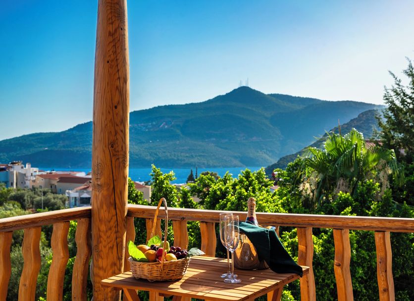 Elixir Hotel in Kalkan with a wooden terrace overlooking mountains and the sea