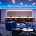 Luma Hotel San Francisco lounge in San Francisco with blue seating, tables, and modern ceiling lighting