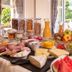 Breakfast buffet at Goldener Adler Oberried - Hotel & Appartements in Oberried with fruit, cheese and pastries