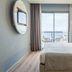 AZ Hotel Vague D'or Algiers guest room with sea view, balcony chairs, and modern bed