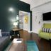 The Oxford at Pike Place Market Seattle suite with sofa, TV, and kitchenette