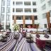 Novotel Dammam Business Park lobby with palm trees, lounge seating, and tall atrium in Dammam