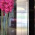 Tumike Hotel Bentong elevator lobby with pink orchid arrangement and black glossy walls