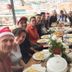 Guests sharing a long table at El Cafecito Hostel Cuenca in Cuenca with city views from the terrace