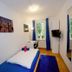 Basement Rotherbaum Hamburg guest room with twin bed, blue accents, window, wall TV and mirror
