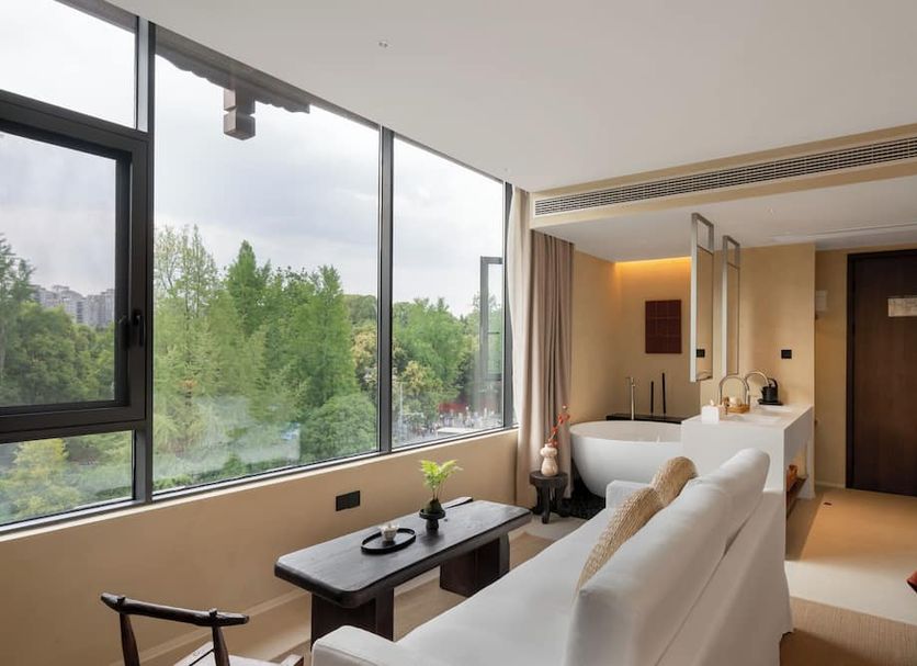 Terra Art Sky Garden Boutique Hotel Chengdu room with floor-to-ceiling windows and city greenery view