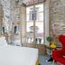 Hotel Calimala Florence bedroom with stone walls, large open window, and city view in Florence