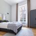 Limehome Baden-Baden Bäderstraße bedroom with double bed, wardrobe and tall window in Baden-Baden