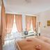 Hotel Goldener Hecht in Heidelberg guest room with twin beds, peach curtains, and street-facing windows