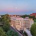 Hampton by Hilton Oswiecim in Oświęcim at dusk with city views and surrounding trees