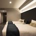 The Knot Tokyo Shinjuku guest room with two beds, wood-paneled wall, and city hotel interior in Tokyo