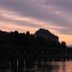 Sunset lake view at Albergo Del Sole, Porto Valtravaglia, with silhouetted trees and mountains
