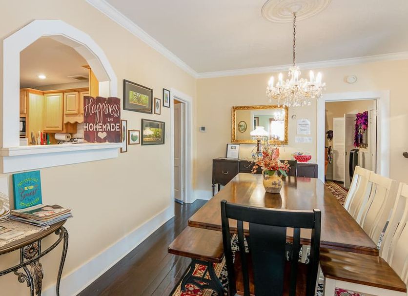 Dining room at The Wayward Traveler's Inn in Mims with long wooden table, chandelier and wall mirror