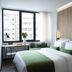 The Port Square Hotel in Piraeus guest room with twin beds, large window, and desk