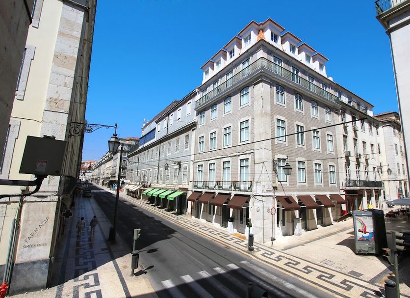 Lisboa Prata Boutique Hotel in Lisbon, corner street view of the hotel exterior under blue sky