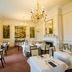 The Upper House in Stoke-on-Trent dining room with chandeliers, white-clothed tables, and framed wall art
