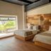 Mayan Monkey Cancun | Social Hotel in Cancún guest room with two beds and wood-paneled accent wall