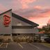 Red Roof Inn Greenville exterior at sunset with parking lot and accessible entrance
