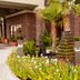 Hampton Inn & Suites Shreveport/South in Shreveport, palm-lined entrance with flowers and fountain