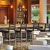 Presidential Suites by Lifestyle in Puerto Plata lounge bar with stools, seating, and lit shelves