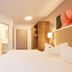 Hotel garni Sonnenhof in Moritzburg: bright guest room with twin beds, wardrobe and floral wall art